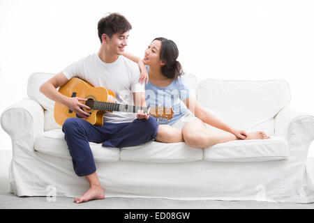Young man playing guitar for his girlfriend Stock Photo