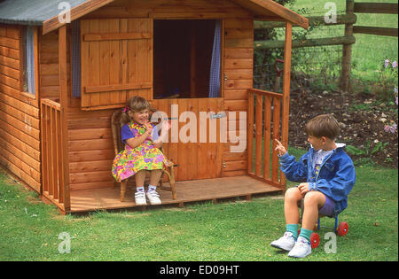 Young children playing outside Wendy House, Princes Risborough, England, United Kingdom Stock Photo