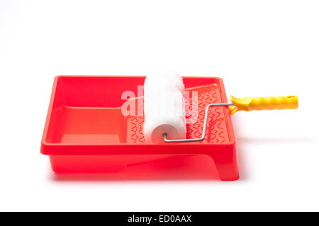 Photo of a paint tray and roller isolated on white background. Stock Photo