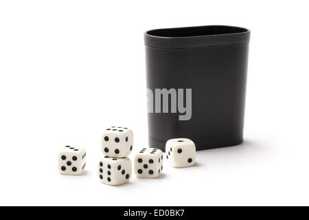 White dices on a pile and cup isolated on white background. Stock Photo