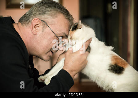 Man cuddling his cat Stock Photo