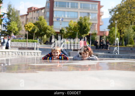 Little boy (6-7) and girl (4-5) playing outside Stock Photo