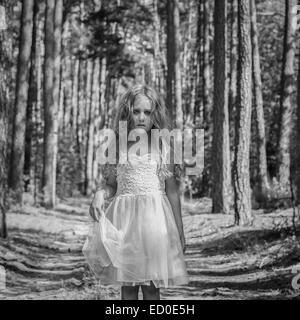 Portrait of sad girl (4-5) in forest