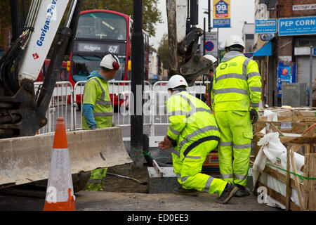 LONDON - OCTOBER 15TH: Unidentified workman using a sprobst vacuum stone magnet by Turnpike lane station on October 15th, 2014 i Stock Photo