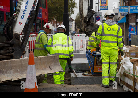 LONDON - OCTOBER 15TH: Unidentified workman using a sprobst vacuum stone magnet by Turnpike lane station on October 15th, 2014 i Stock Photo