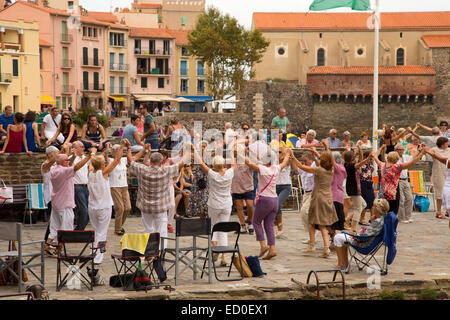 LONDON - SEPTEMBER 27TH: Catalan people dance their traditional Sardane on September 27th, 2014, in Collioure, France. Collioure Stock Photo