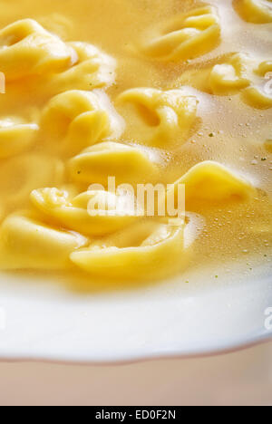 plate of warm italian pasta tortellini in broth Stock Photo