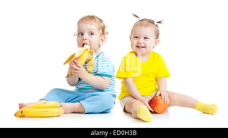 Baby boy and girl eating fruits isolated Stock Photo