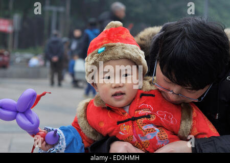Cute baby boy in chinese costume with his father Stock Photo