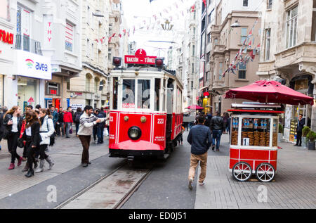 Istanbul, Turkey - November 14, 2014: A red tram makes its way alongside shoppers crowding İstiklal Avenue (Independence Avenue) Stock Photo