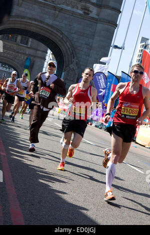 LONDON - APRIL 13: Unidentified men run the London marathon on April 13, 2014 in London, England, UK. The marathon is an annual  Stock Photo
