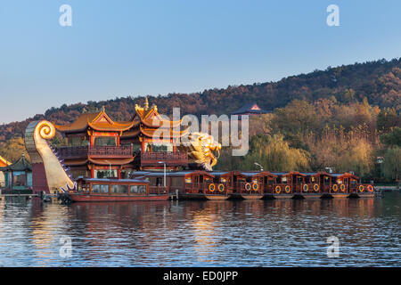 Hangzhou, China - December 5, 2014: Traditional Chinese wooden pleasure boats and Dragon ship stand on the West Lake. Famous par Stock Photo