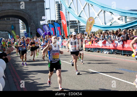 LONDON - APRIL 13: Unidentified men run the London marathon on April 13, 2014 in London, England, UK. The marathon is an annual  Stock Photo