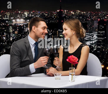 young couple with glasses of wine at restaurant Stock Photo