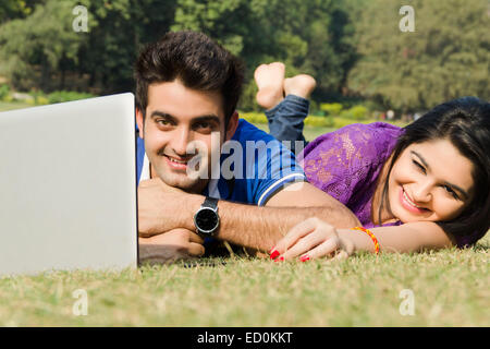 2 indian couple park laptop working Stock Photo