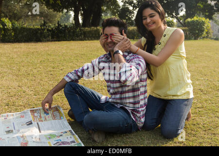 2 indian couple park fun Covering Eyes Stock Photo