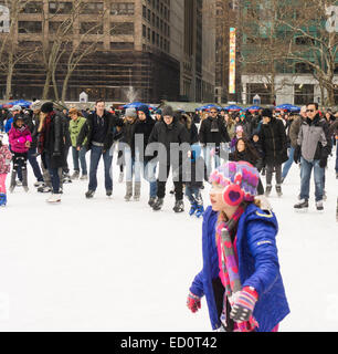 Skaters maneuver the packed Bank of america Winter Village ice skating rink at Bryant Park in New York on Sunday, December 21, 2014. (© Richard B. Levine) Stock Photo