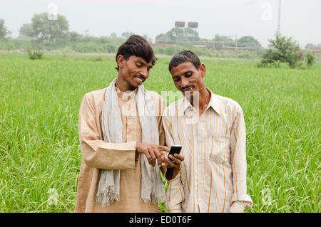 2 indian rural farmer man Field Dialing phone Stock Photo