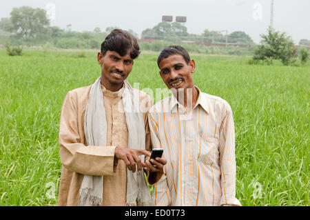 2 indian rural farmer man Field Dialing phone Stock Photo