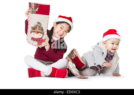 Happy sister and brother in Santa hats Stock Photo