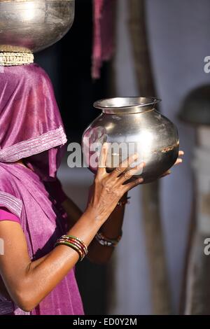 Indian woman carrying a pot of water India Stock Photo