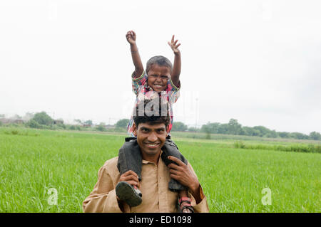 indian rural father with child field fun Stock Photo