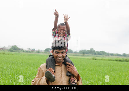 indian rural father with child field fun Stock Photo