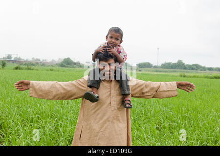 indian rural father with child field fun Stock Photo