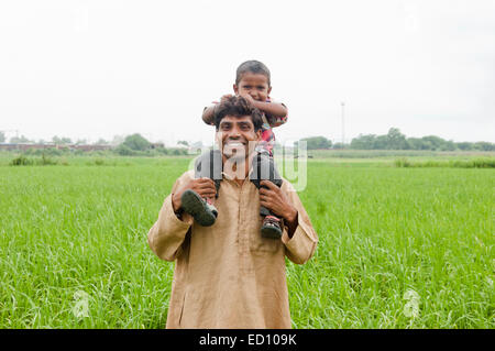 indian rural father with child field fun Stock Photo