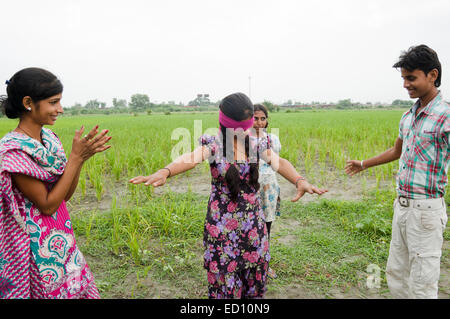 indian boy and girls farm playing Hide and Seek Stock Photo