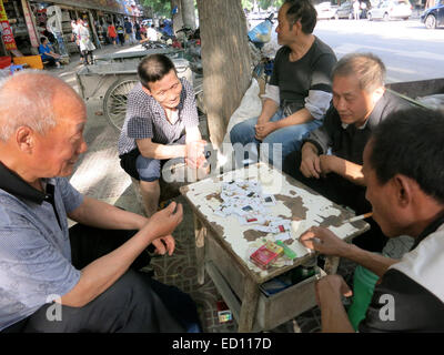 Chinese men playing cards in street Xian China Stock Photo