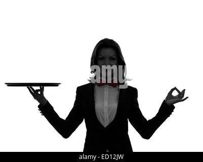 one  woman waiter butler holding empty tray zen gesturing in silhouette on white background Stock Photo