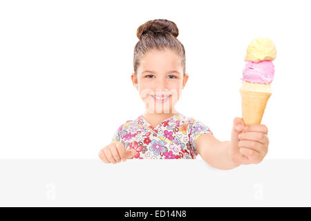 Little girl holding an ice cream behind billboard isolated on white background Stock Photo