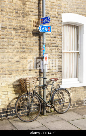 Black vintage bicycle parked outside a College in Cambridge Cambridgeshire England United Kingdom UK Stock Photo