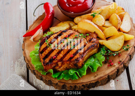 Grilled steak on the bone with potatoes Stock Photo