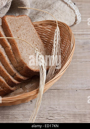 slices of rye bread and ears of corn in the basket Stock Photo