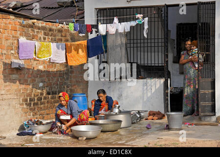 Village women doing laundry in front of home, Gujarat, India Stock Photo