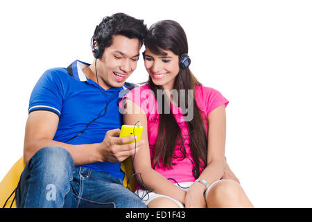 2 indian Beautiful Couple Phone Hearing Music Stock Photo