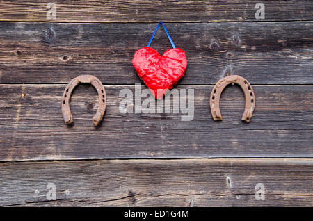 wooden heart with symbols of luck red heart, coin, clover and ladybug, Stock image