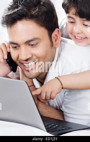 indian father with child enjoy Watching laptop Stock Photo