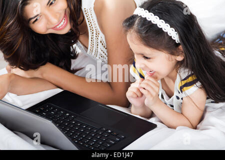 indian mother with child enjoy Watching laptop Stock Photo