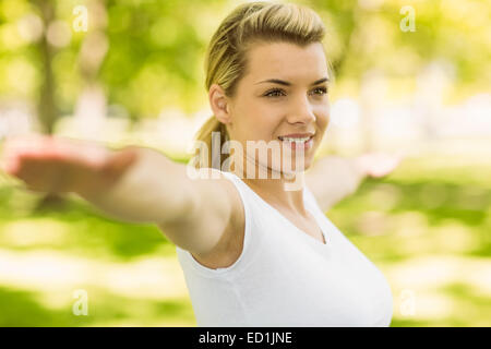 Peaceful blonde doing yoga in the park Stock Photo