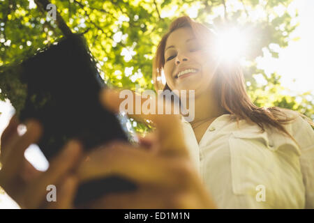 Pretty redhead text messaging on her phone Stock Photo