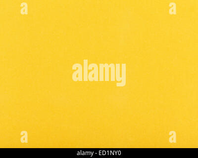 background from sheet of dark yellow color velvet paper close up Stock Photo