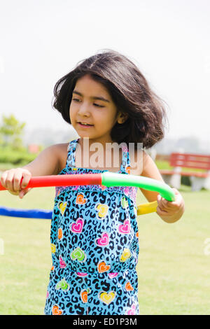 1 indians Child girl  park playing Hulahoop Stock Photo