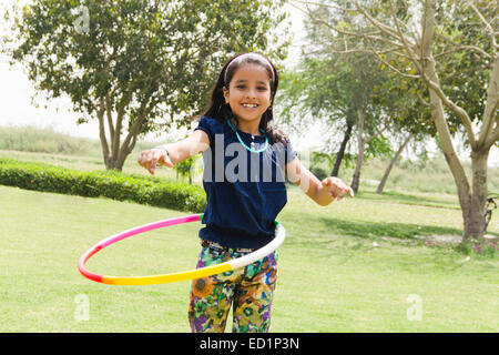 1 indians Child girl  park playing Hulahoop Stock Photo