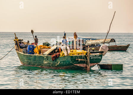 Local fishermen on a traditional boat at the shore of Indian ocean near Stone Town, Zanzibar Stock Photo