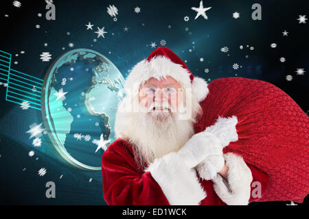 Composite image of jolly santa carries his sack Stock Photo