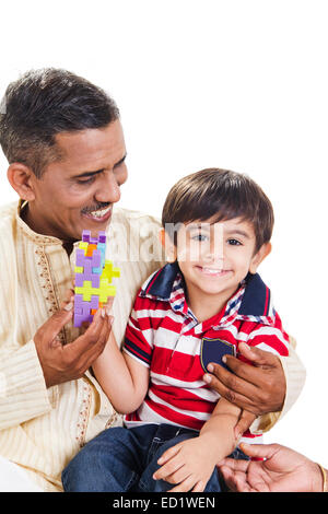 indian grandfather and grandson playing toy Stock Photo