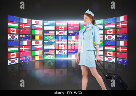 Composite image of pretty air hostess pulling suitcase Stock Photo